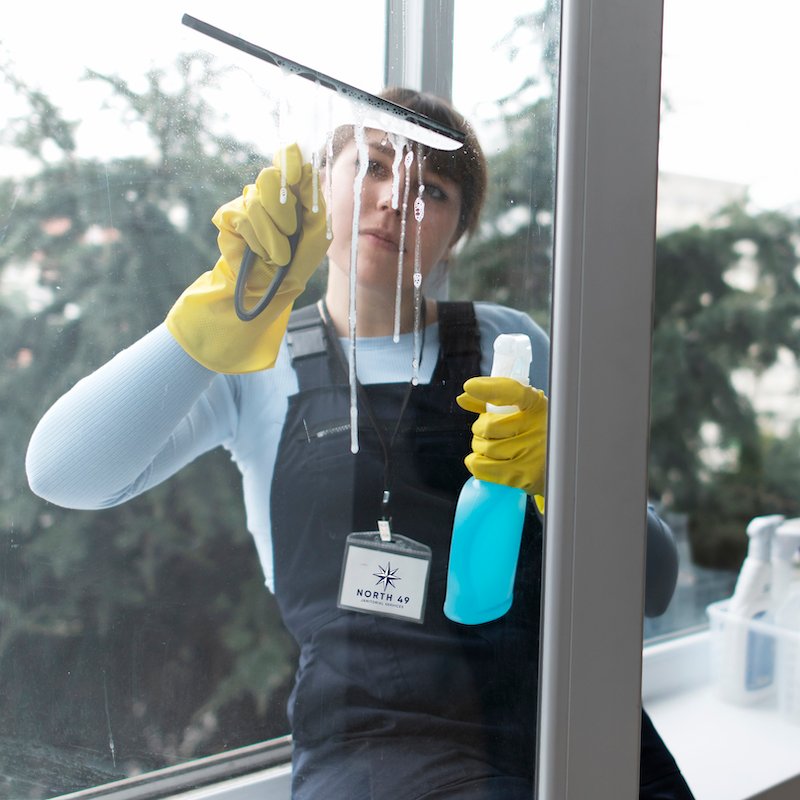 North 49 employee cleaning windows